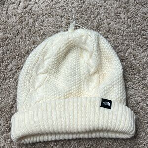 The north face women’s cableknit, cream color beanie, missing pom-pom one size